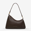 Status Anxiety Reverie Bag Cocoa — the Reverie Bag in Cocoa with brushed gold hardware by Status Anxiety is an easy statement piece with a clean, sculptural shape.