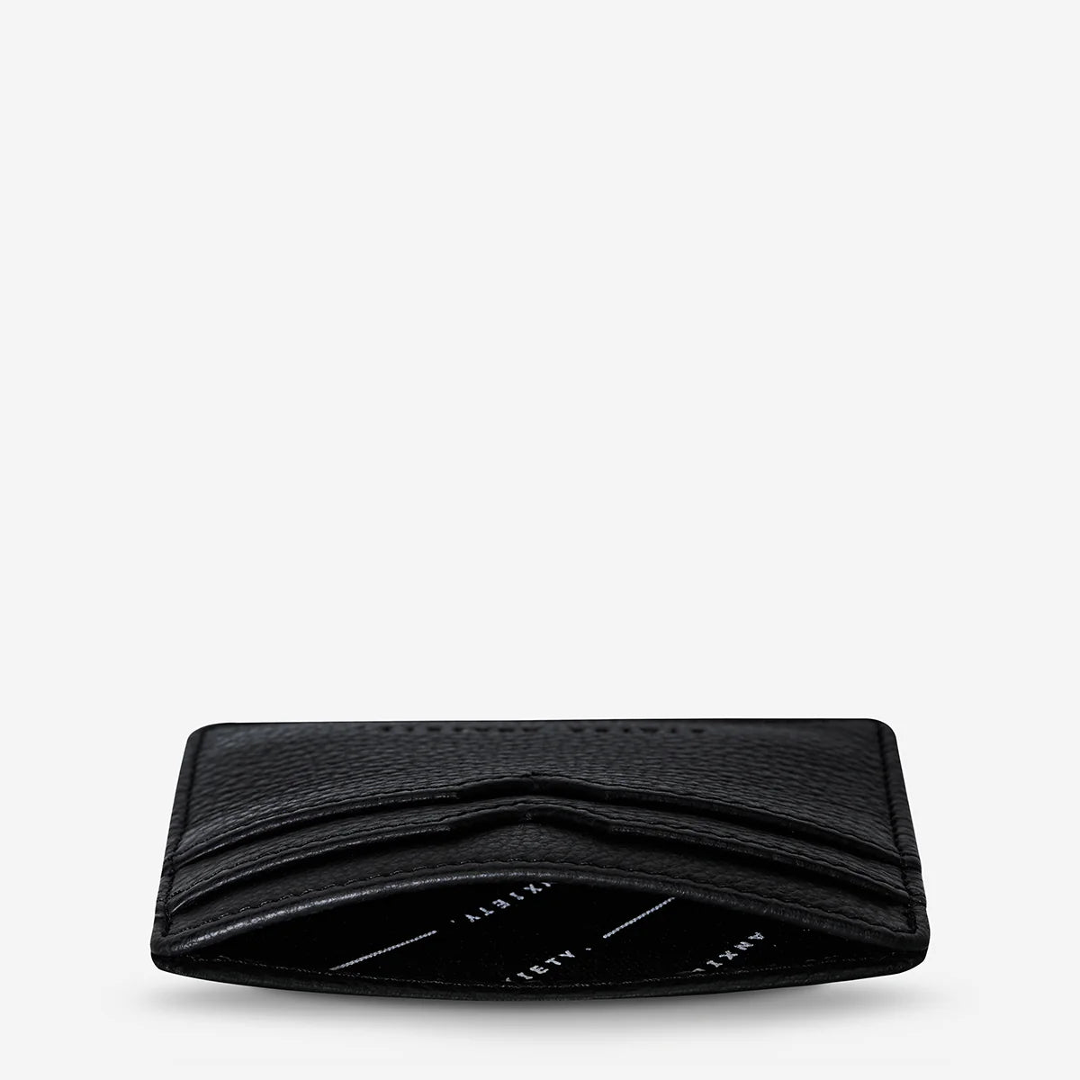 Status Anxiety Together For Now Wallet in Black — crafted from soft, shrunken pebble leather, this sleek cardholder combines durability with refined style.