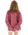 The red long-sleeve tee is shown from the back, highlighting the floral print and dropped shoulders.