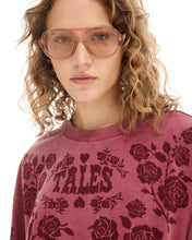 A close-up shows the crew neckline, acid-wash finish and distorted rose graphic on the red tee.