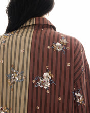A close-up of the back shows the brown and beige stripes with floral bead and sequin embellishments.
