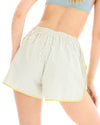 Back three-quarter view of sage and white striped runner shorts showing the elasticated waistband and curved hem.