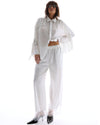 The Tales Frida Lace Hem Floral Pants in White — the Tales Frida Lace Hem Floral Pants offer an elevated take on relaxed tailoring with delicate lace trim detailing and an effortless silhouette.