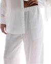 The Tales Frida Lace Hem Floral Pants in White — the Tales Frida Lace Hem Floral Pants offer an elevated take on relaxed tailoring with delicate lace trim detailing and an effortless silhouette.