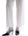 The Tales Frida Lace Hem Floral Pants in White — the Tales Frida Lace Hem Floral Pants offer an elevated take on relaxed tailoring with delicate lace trim detailing and an effortless silhouette.