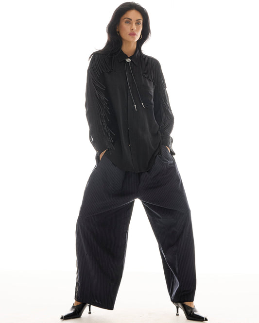 The Tales Harajuku Pin Stripe Tuxedo Wool Pants in Black — the Tales Harajuku Pin Stripe Tuxedo Wool Pants combine classic tailoring with a relaxed modern silhouette.