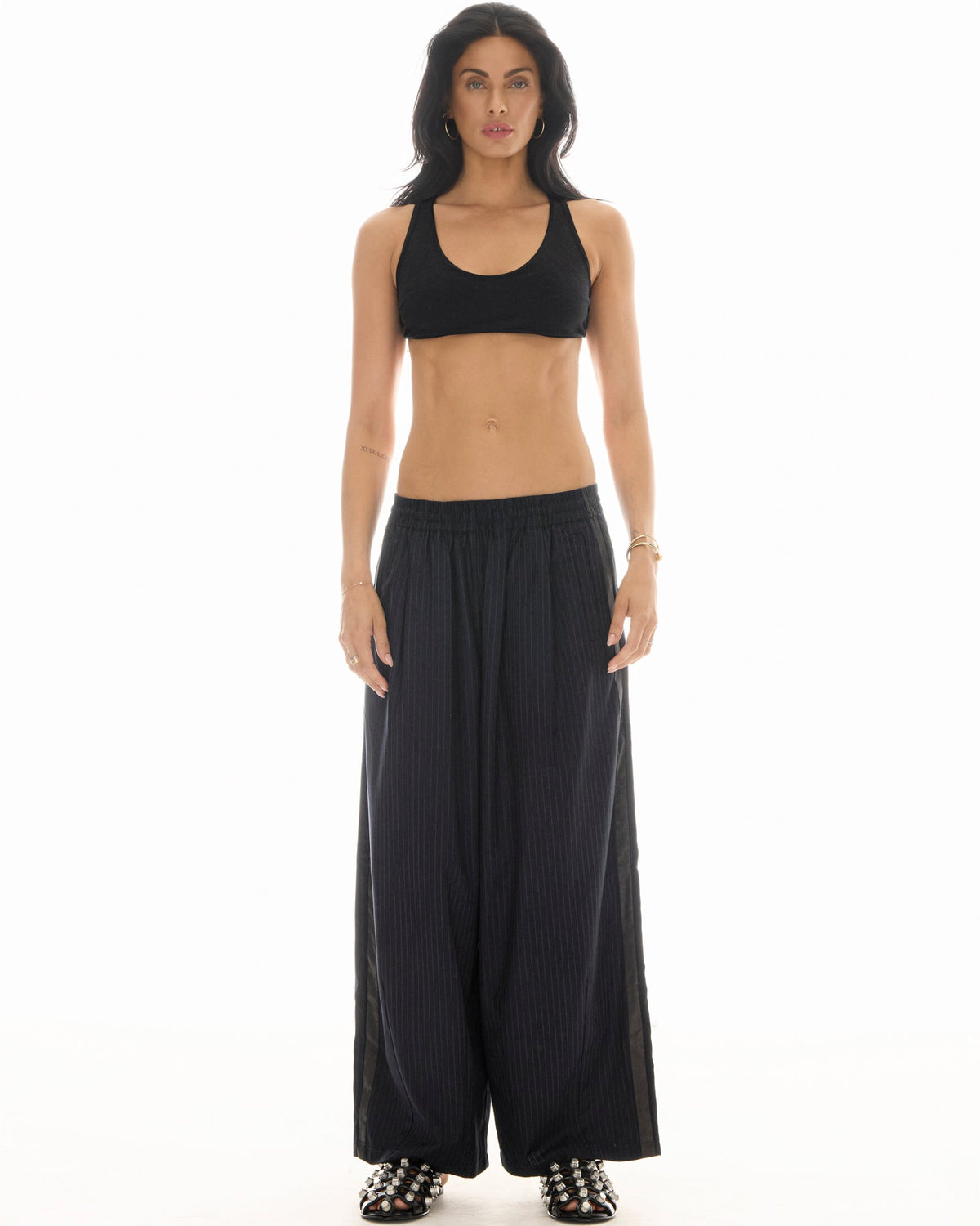 The Tales Harajuku Pin Stripe Tuxedo Wool Pants in Black — the Tales Harajuku Pin Stripe Tuxedo Wool Pants combine classic tailoring with a relaxed modern silhouette.