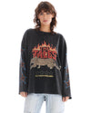 Close front view of the oversized acid-wash long sleeve tee showing the flame, leopard and slogan graphic with star prints along the sleeves.