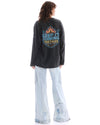 Full-length back view highlighting the large flame and Keep It Coming graphic across the acid-wash long sleeve tee.