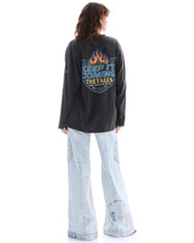Full-length back view highlighting the large flame and Keep It Coming graphic across the acid-wash long sleeve tee.