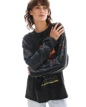 Close front pose highlighting the leopard-print star sleeve graphics, crew neckline and washed finish of the oversized tee.
