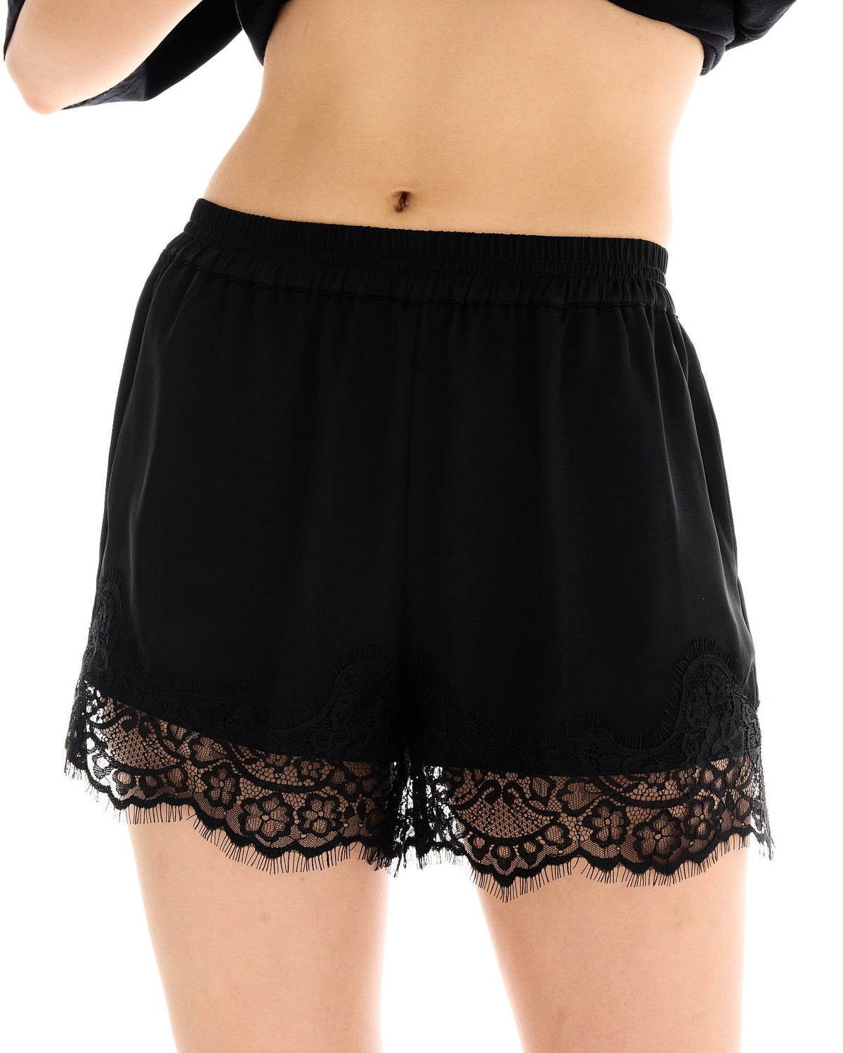 Close-up front view of black shorts showing the elasticated waistband and Chantilly lace detail.
