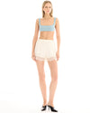 Full front view of the cream pull-on shorts styled with a cropped blue top and black heels.