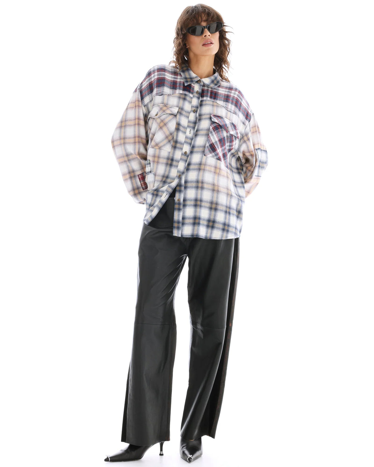 A model wears The Tales Patched Up Western Shirt in Cream with black wide-leg trousers in a full-length front view.