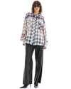 A model wears the oversized cream mixed-plaid shirt in a full-length front view.