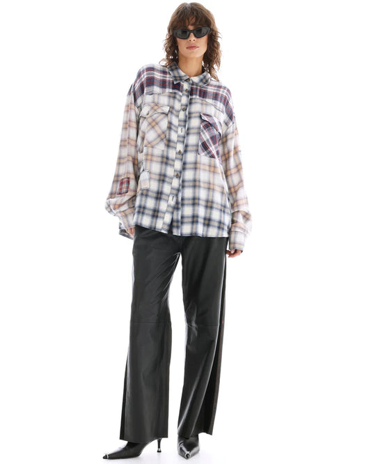 A model wears the oversized cream mixed-plaid shirt in a full-length front view.