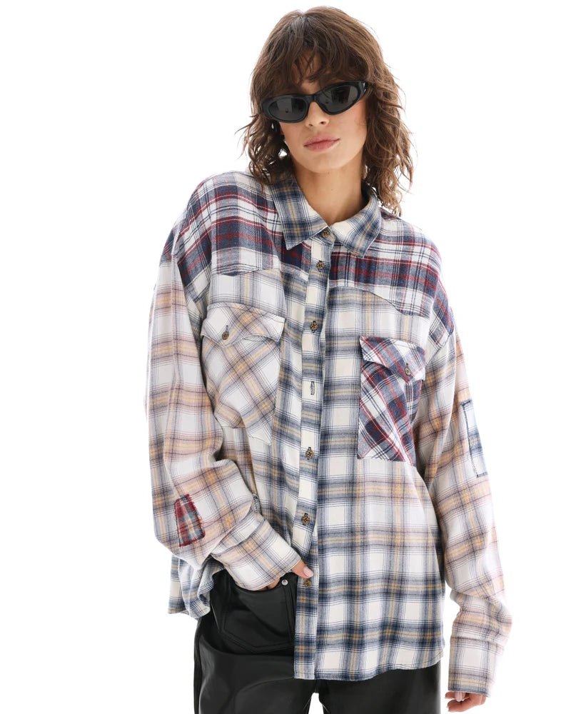 A model wears the cream button-through shirt in a three-quarter front view showing the contrasting chest pockets.