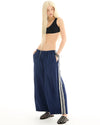 The Tales The Harajuku track Pant — the Harajuku Track Pant by The Tales Contemporary Unisex wide leg track pants with contrast stripe tape.