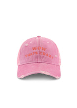 Front product view of the pink trucker cap highlighting the curved embroidered slogan and distressed detailing against a white background.